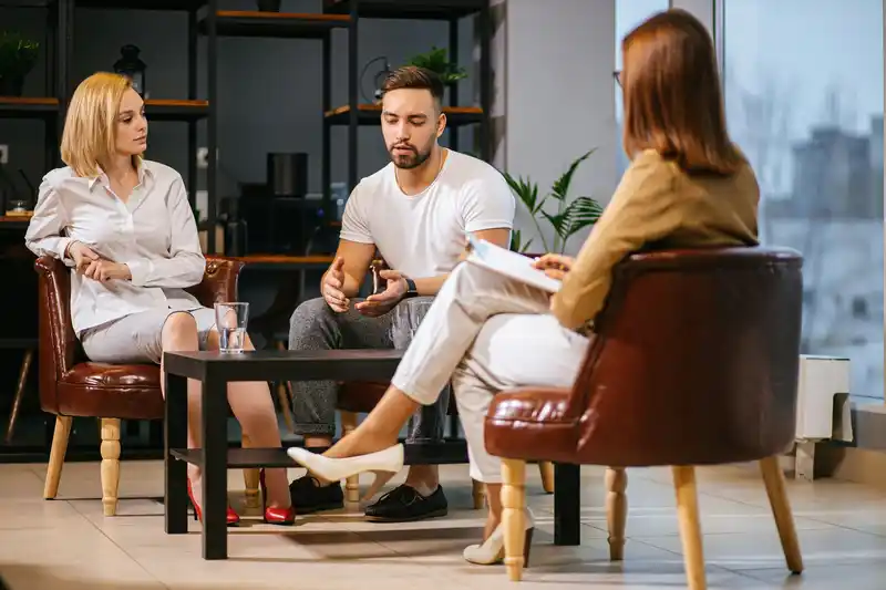 A couple talking with a therapist during a counseling session